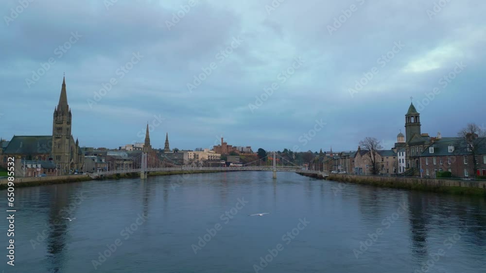 Forwards fly above Ness river with its bridges in historic city centre in Inverness. Aerial view of sights on waterfronts. Scotland, UK Forwards fly above Ness river with its bridges in historic city centre in Inverness. Aerial view of sights on waterfronts. Scotland, UK