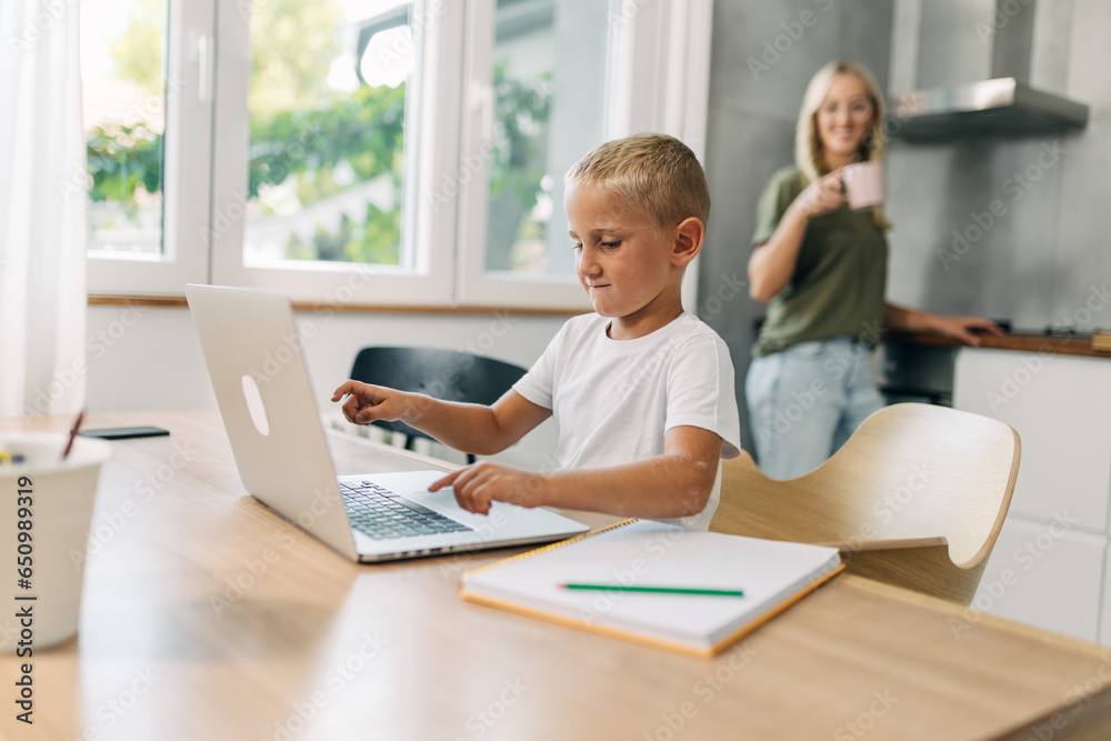 Preschool boy is learning how to use laptop. Preschool boy is learning how to use laptop.
