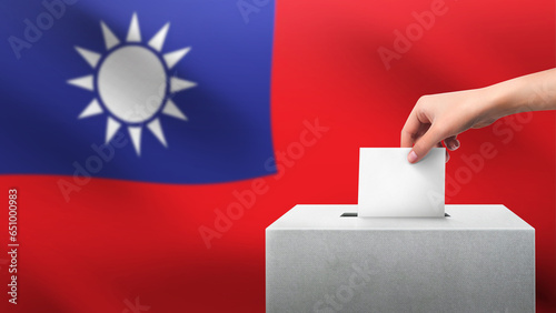 Woman puts ballot paper in voting box on TAIWAN flag background. Election concept.