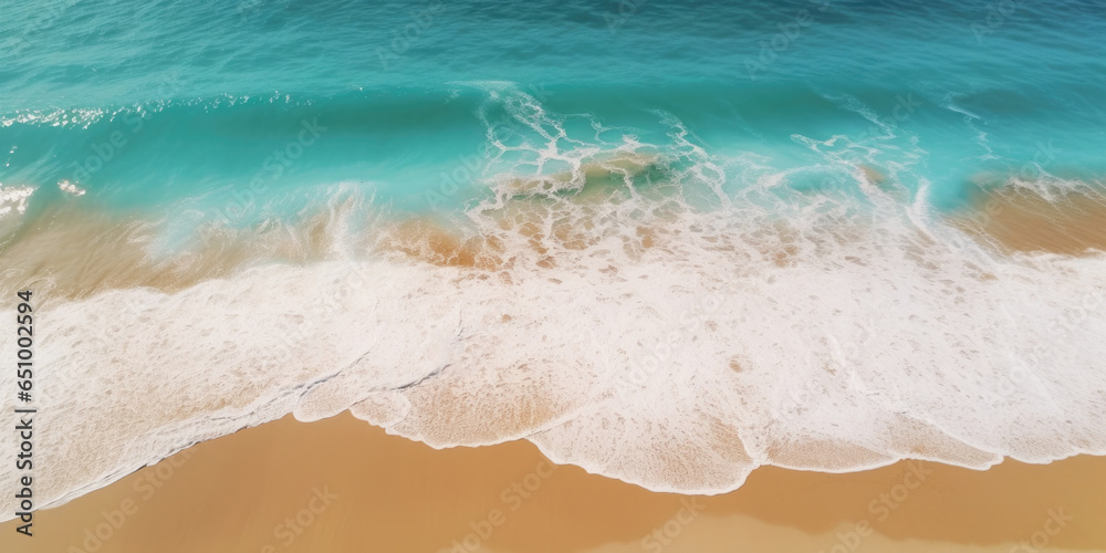 Aerial view of beautiful beach with turquoise water and white sand. Top view of a beach with waves breaking on the sand. 