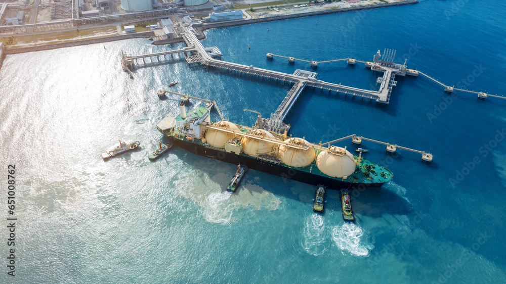 LNG (Liquefied natural gas) tanker anchored in Gas terminal gas tanks for storage. Oil Crude Gas Tanker Ship. LPG at Tanker Bay Petroleum Chemical or Methane freighter export import transportation