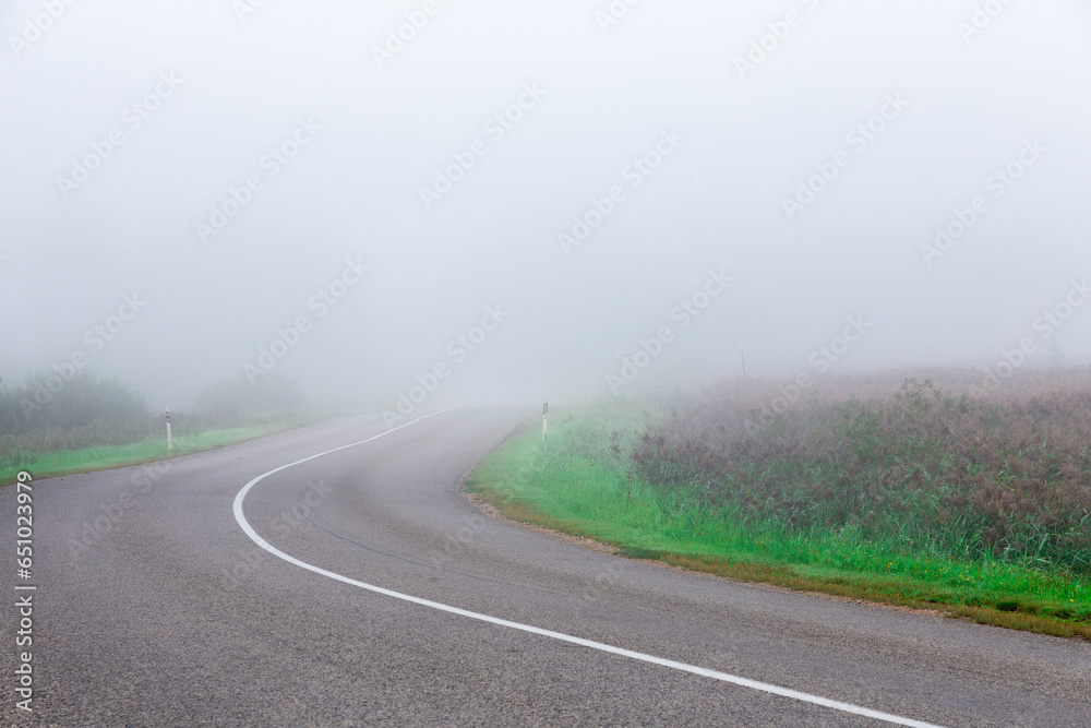 foggy and cool morning on the highway, in the field during summer foggy and cool morning on the highway, in the field during summer