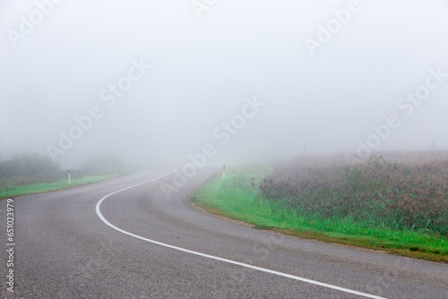 foggy and cool morning on the highway, in the field during summer