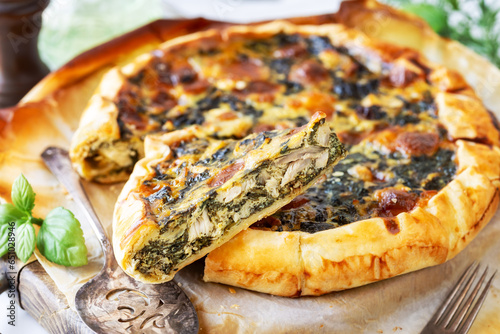 Chicken and spinach savoury pie on parchment paper photo