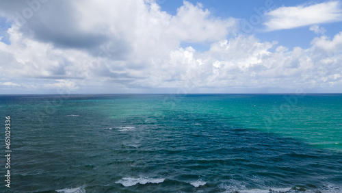 Aerial view blue sea and clouds reflection on the sea surface, natural colors, blue background