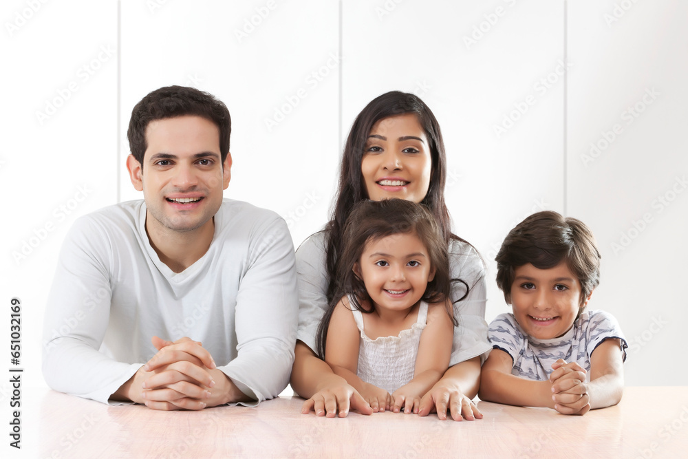 Portrait of parents with their son and daughter smiling Portrait of parents with their son and daughter smiling
