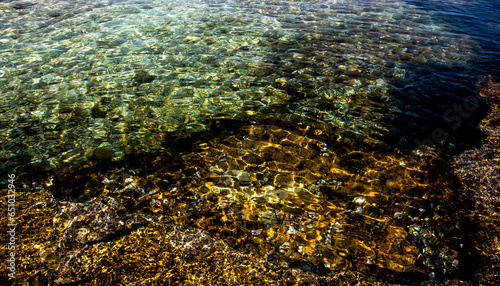 Clear shallow water with rocky bottom.