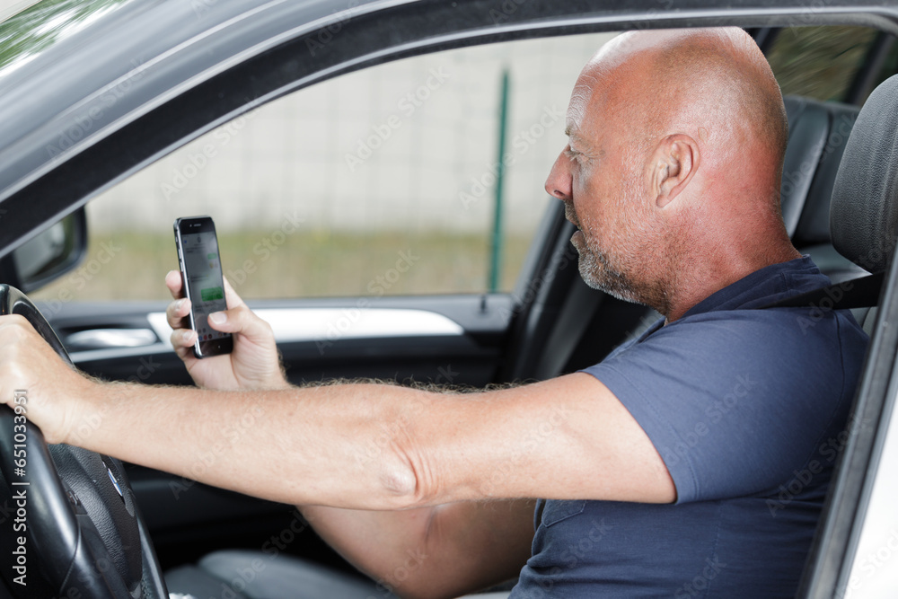 confident man with phone in car confident man with phone in car