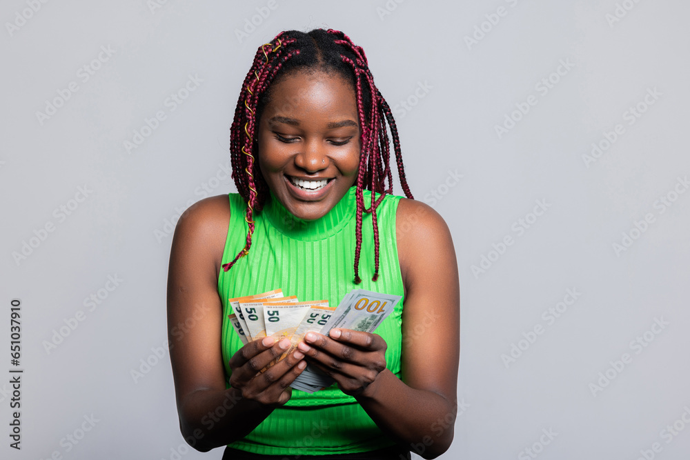 Young African American woman with colourful stylish braids counting ...