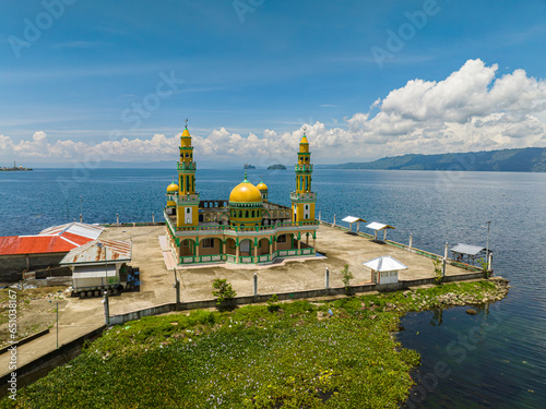 Linuk Masjid a mosque beside the Lake Lanao in Lanao del Sur. Blue sky and clouds. Mindanao, Philippines. photo