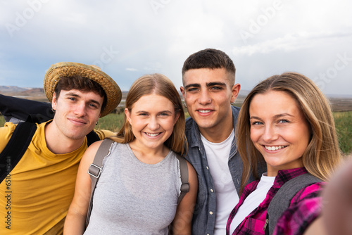 Group of friends taking selfie outdoors