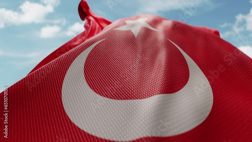 Wavy flag of Turkey blowing in the wind in slow motion. Waving official Turkish flag team symbol abstract vertical background. Blue sky with clouds. World countries flying flags concept photo