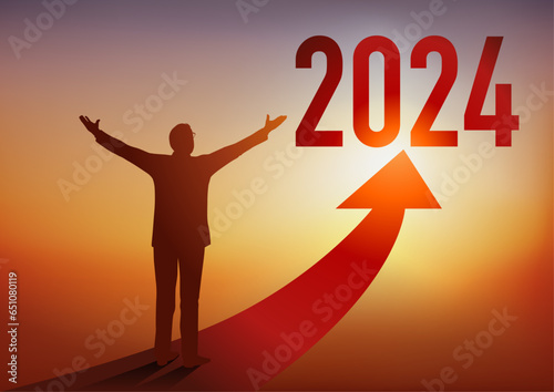 Carte de vœux 2024 montrant un homme d’affaires ouvrant les bras devant une flèche rouge en direction d’un horizon ensoleillé, symbole d’espoir et de réussite.