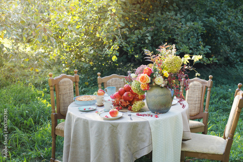 apple pie on laid table in  garden on sunny day