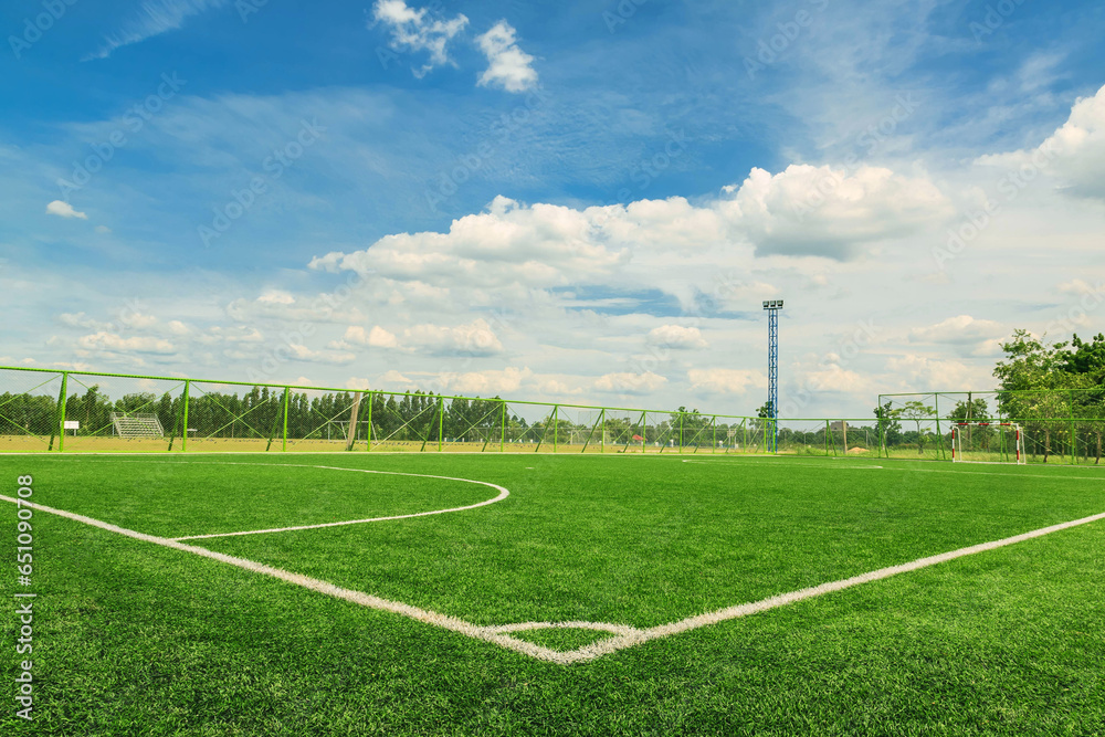 Green synthetic grass sports field with white line shot from above. background