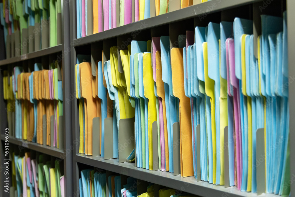 File folders paper for keep in order data sheet in filing shelves. Paper document color folder in storage room. - obrazy, fototapety, plakaty 