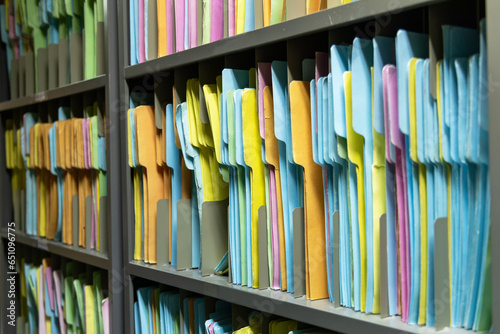 File folders paper for keep in order data sheet in filing shelves. Paper document color folder in storage room.