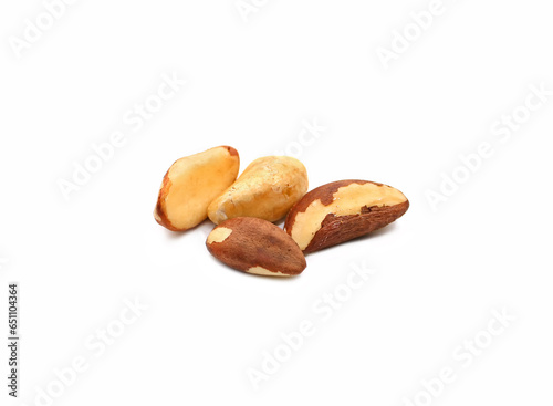 Delicious Brazil nuts isolated on white background. Group of tasty healthy ripe shelled Brazil nuts. Organic product. Side view. Selective focus.