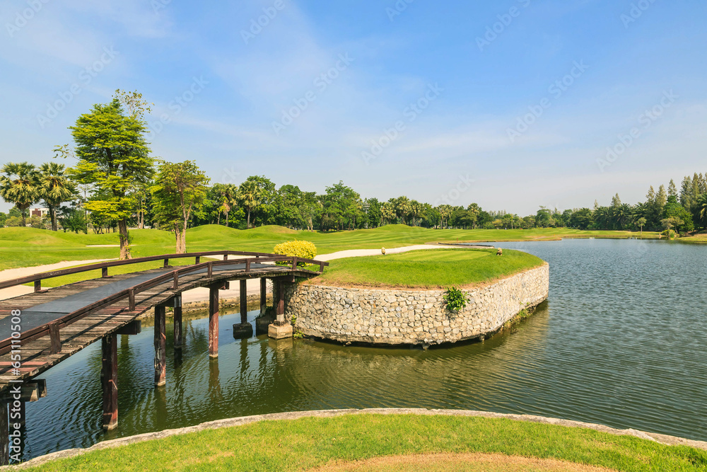 Beautiful green golf course and beautiful pond.