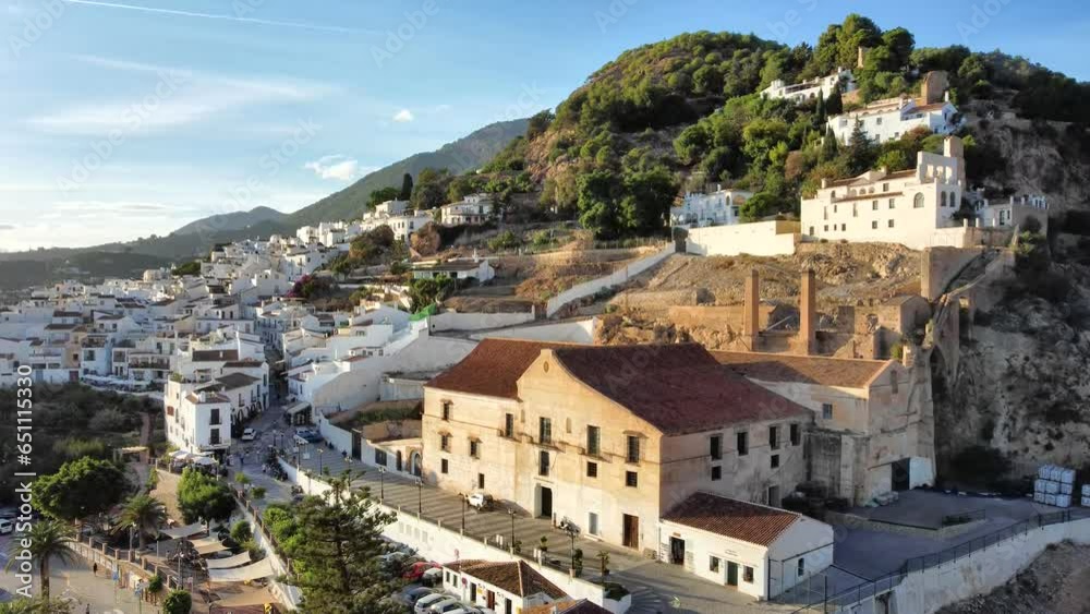 Aerial side view slowly approaching Palacio de los Condes de Frigiliana.
Frigiliana is one of the prettiest and most famous Moorish white villages in Andalucia and a popular tourist destination. Aerial side view slowly approaching Palacio de los Condes de Frigiliana.
Frigiliana is one of the prettiest and most famous Moorish white villages in Andalucia and a popular tourist destination.