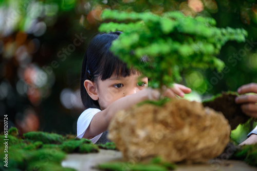 Young boy and girl make a little plant garden
