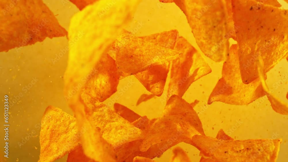 Super slow motion of flying tortilla chips on color gradient background. Filmed on high speed cinema camera, 1000 fps. Camera placed on high speed cine bot, tracking the target. Super slow motion of flying tortilla chips on color gradient background. Filmed on high speed cinema camera, 1000 fps. Camera placed on high speed cine bot, tracking the target.