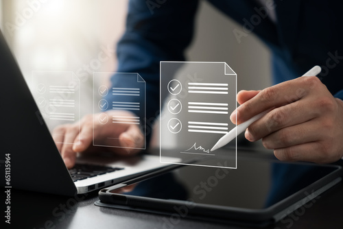 Electronic Signature Concept, Electronic Signing Businessman signs electronic documents on digital documents on virtual laptop screen using stylus pen.