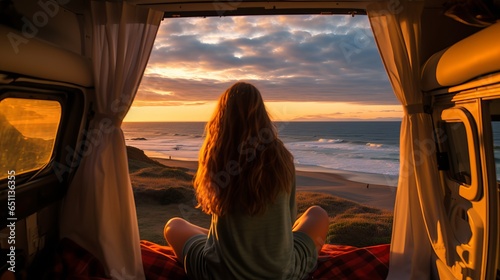Young woman enjoying a beautiful view of a beach from her camper.