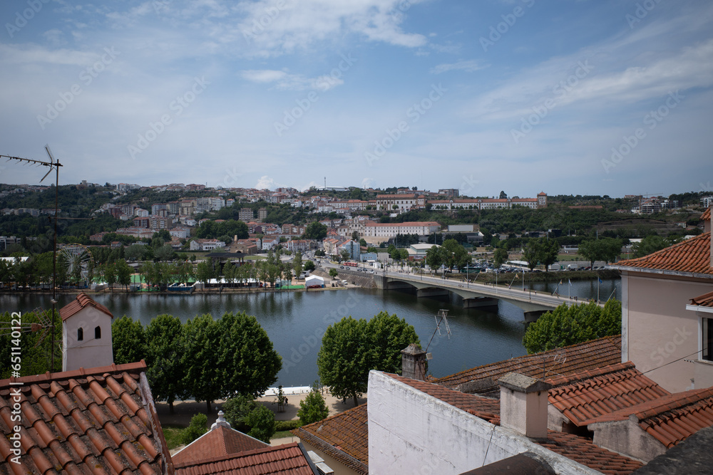 A view of the river in Coimbra looking down from the hill to the valley with buildings in the foreground and river in the background