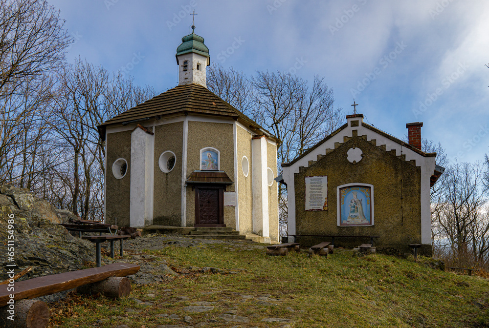 The old mountain chapel on the top of the mountain in the Bardzkie Mountains, view from the hiking trail.