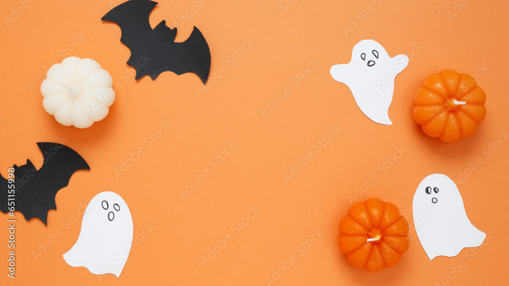 Halloween set decorations with pumpkins, ghost, bat on orange background. Happy halloween party. Flat lay, copy space, top view