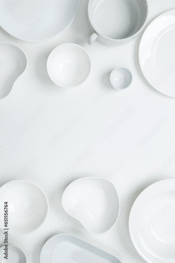 Set of different pure white dishes for home or restaurant on white background. Top view, flat lay, copy space Set of different pure white dishes for home or restaurant on white background. Top view, flat lay, copy space