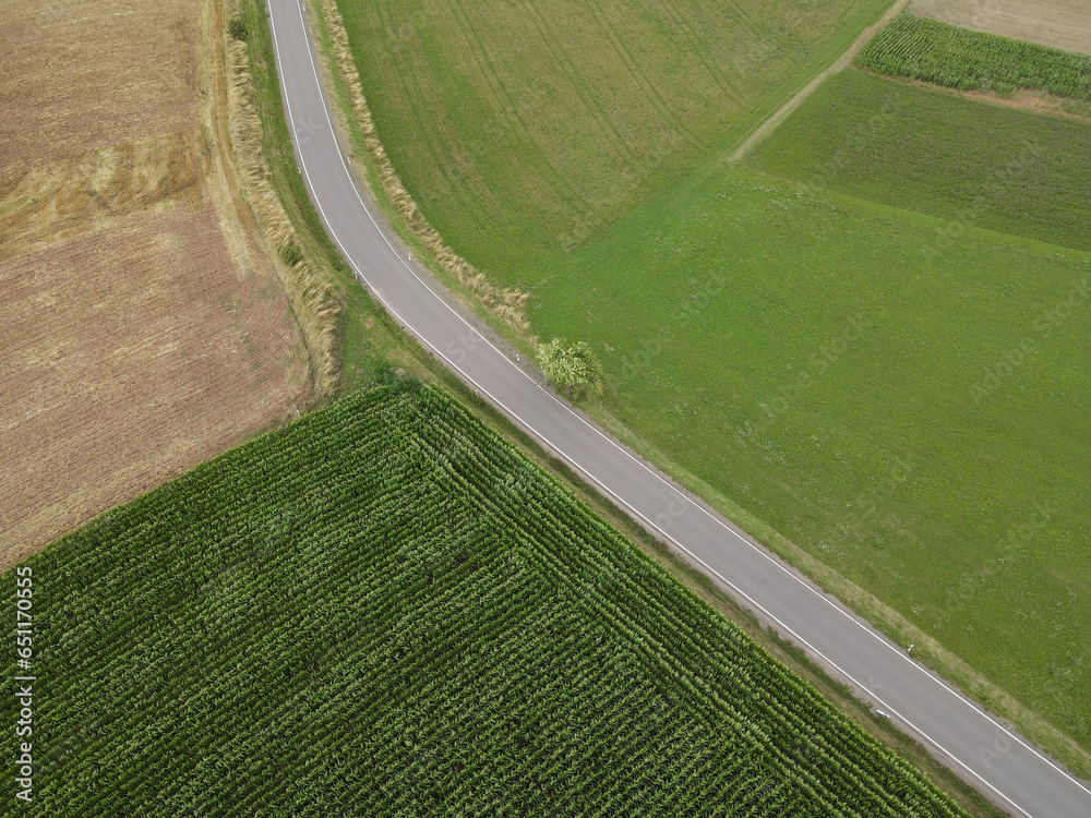 View from above of a road between country fields in the countryside 