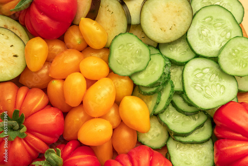 Mixed fresh vegetable background. Healthy eating ingredients. Slice of mix veggies  tomatoes  cucumbers  cherry tomato  eggplant. Nutrition  diet  vegan food. Assorted fruits rotating view closeup