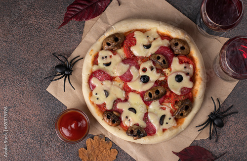 Themed food for Halloween - pizza with cheese ghosts and mushrooms form of skulls, Top view photo