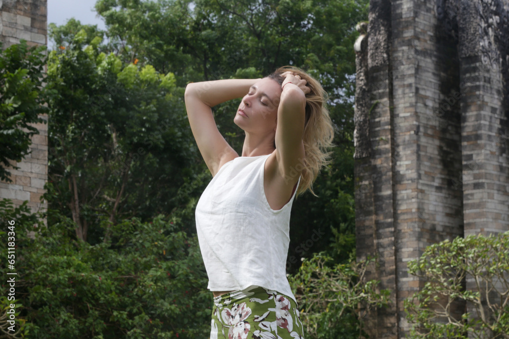 Young woman enjoying windy fresh air in the park, Outdoor portrait of stylish fashionable woman in linen outfit, spring-summer fashion trend Young woman enjoying windy fresh air in the park, Outdoor portrait of stylish fashionable woman in linen outfit, spring-summer fashion trend
