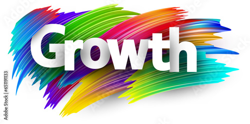 Growth paper word sign with colorful spectrum paint brush strokes over white.
