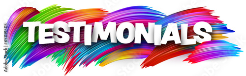 Testimonials paper word sign with colorful spectrum paint brush strokes over white.