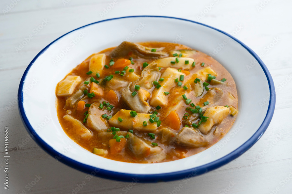 Strips of squid stewed with potatoes, vegetables and broth. Strips of squid stewed with potatoes, vegetables and broth.