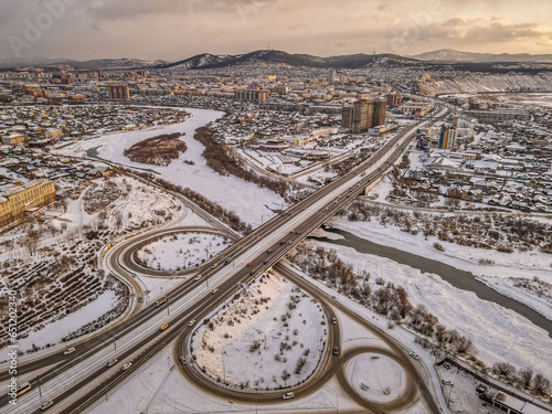 The car bridge and junction over the frozen Selenga river in the Siberian town of Ulan-Ude, Buryatiya, Russia, with the aerial panorama view during the cloudy winter day.
 photo