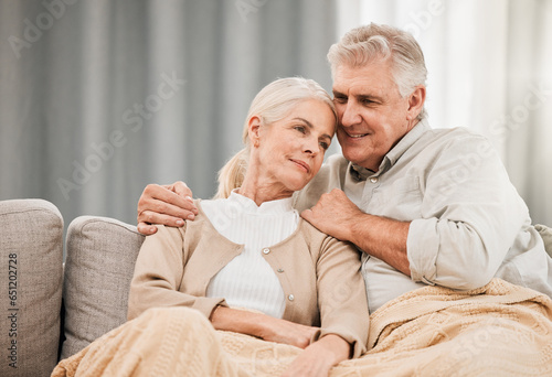 Old couple, hug and relax on couch with love and support, bonding while at home with trust and comfort. People with time together, marriage or life partner with retirement, calm and peace of mind