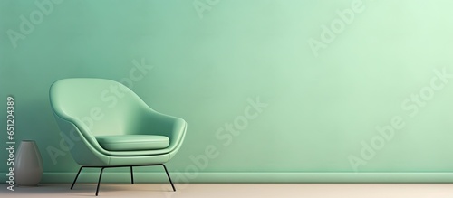 Contemporary designer armchair with a green shade on a isolated pastel background Copy space