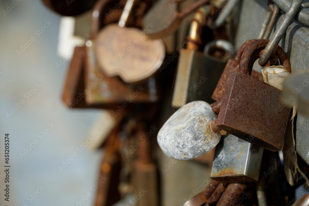 Many rusty padlocks closed on bridge fence - love concept Many rusty padlocks closed on bridge fence - love concept