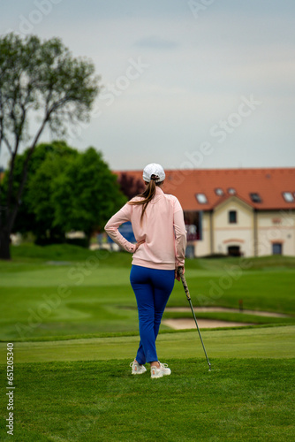 Young women gracefully golfing on a serene course, enjoying a sunny day filled with leisure and sport, perfectly capturing the essence of outdoor recreation.