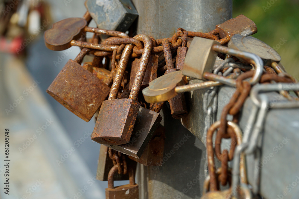 Many rusty padlocks closed on bridge fence - love concept Many rusty padlocks closed on bridge fence - love concept