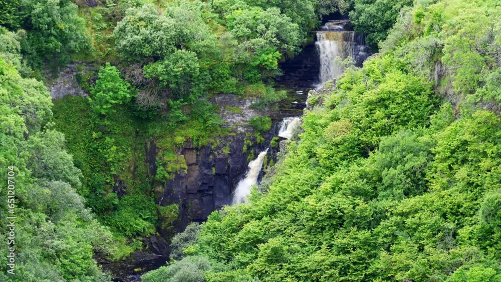 Waterfalls among the lush forest that descend from the high mountains on the Isle of Skye, Scotland. Waterfalls among the lush forest that descend from the high mountains on the Isle of Skye, Scotland.