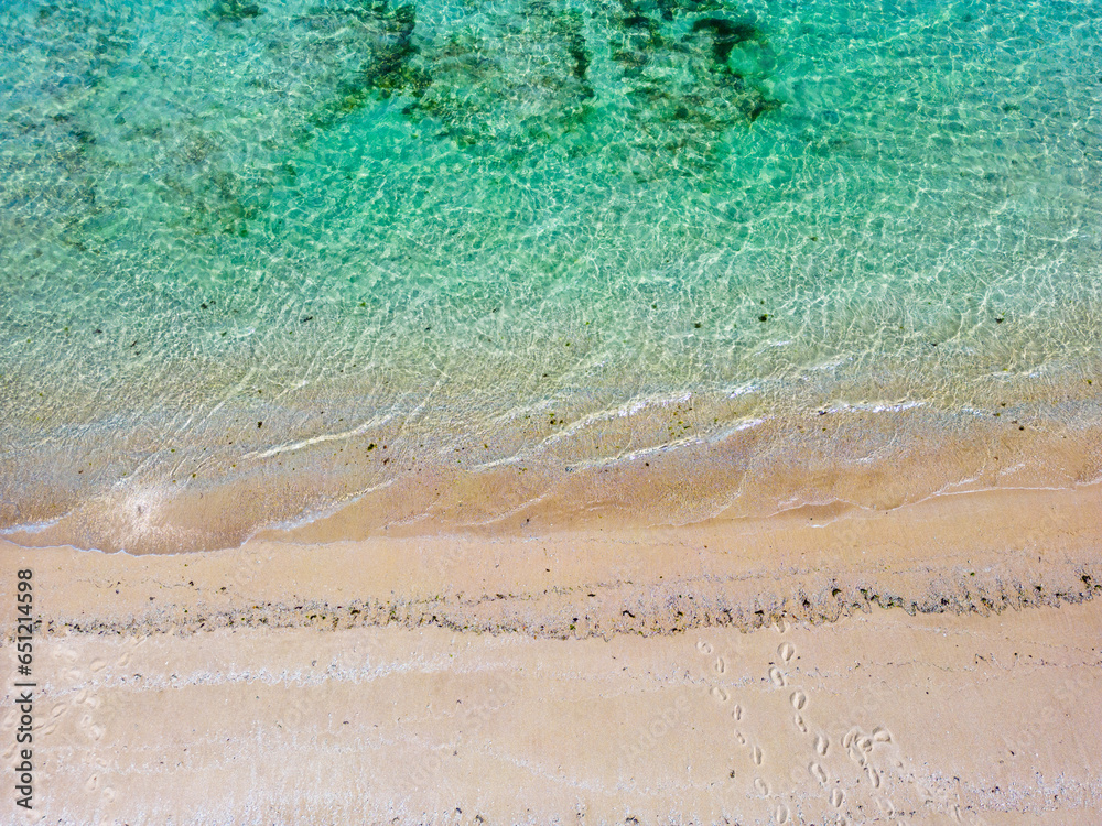 Tropical sandy beach with turquoise ocean drone aerial view, one of the Gili islands in Lombok, Indonesia