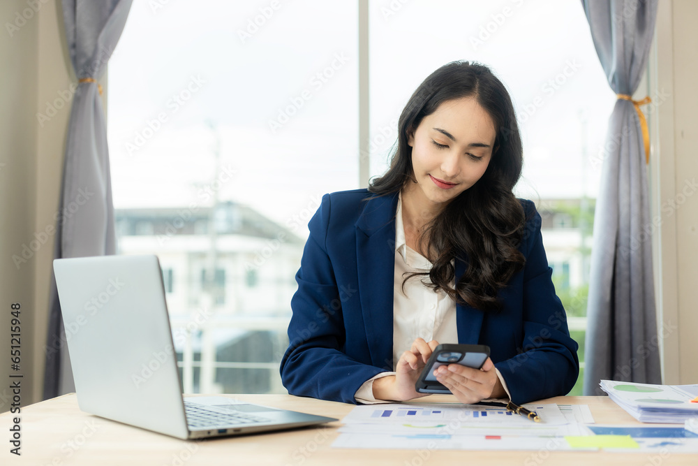 Asian business woman office, working with Financial data sheet doing math on office table, taxes, reports, accounting, statistics and analytical research concepts. In the modern office Asian business woman office, working with Financial data sheet doing math on office table, taxes, reports, accounting, statistics and analytical research concepts. In the modern office