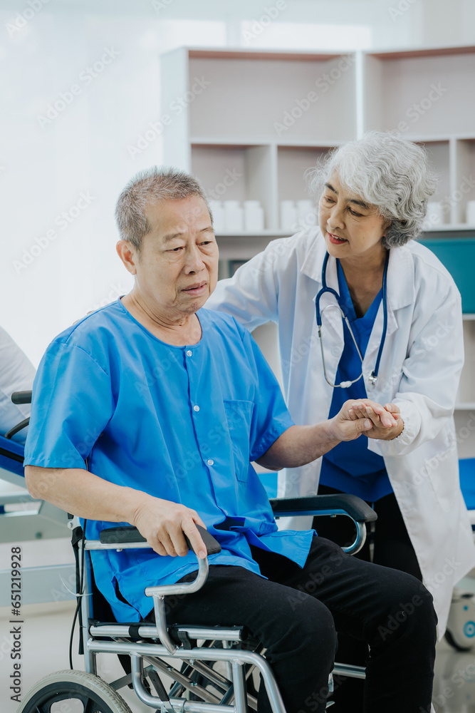 Asian female physical therapist works with an elderly woman to walk with a walker.