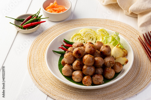 Thai Sausage Feast,fermented pork and rice sausage (Sai Krok Isan) in white plate with vegetables